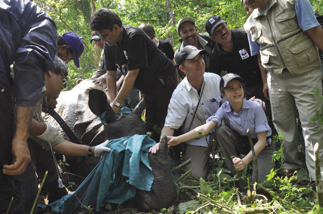 Roberts with his daughter Eliza and a rhino in Nepal in 2012