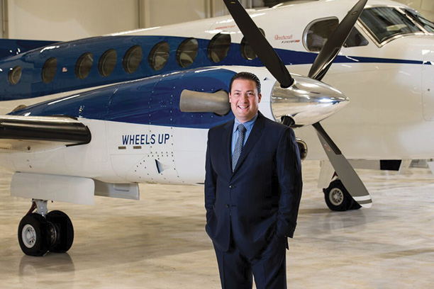 Kenny Dichter in front of a Wheels Up Beechcraft King Air 350i