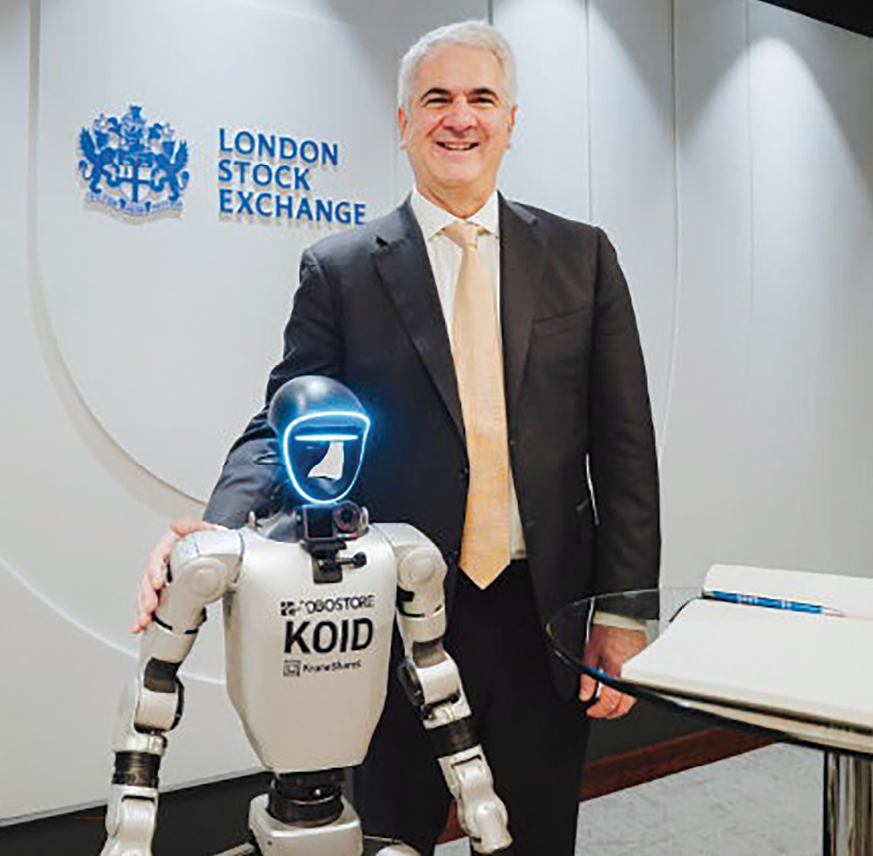 Jonathan Krane with a humanoid robot